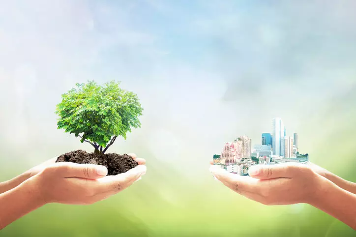 CGI image representing sustainability, one pair of hands holds up a tree while another holds up a city scape