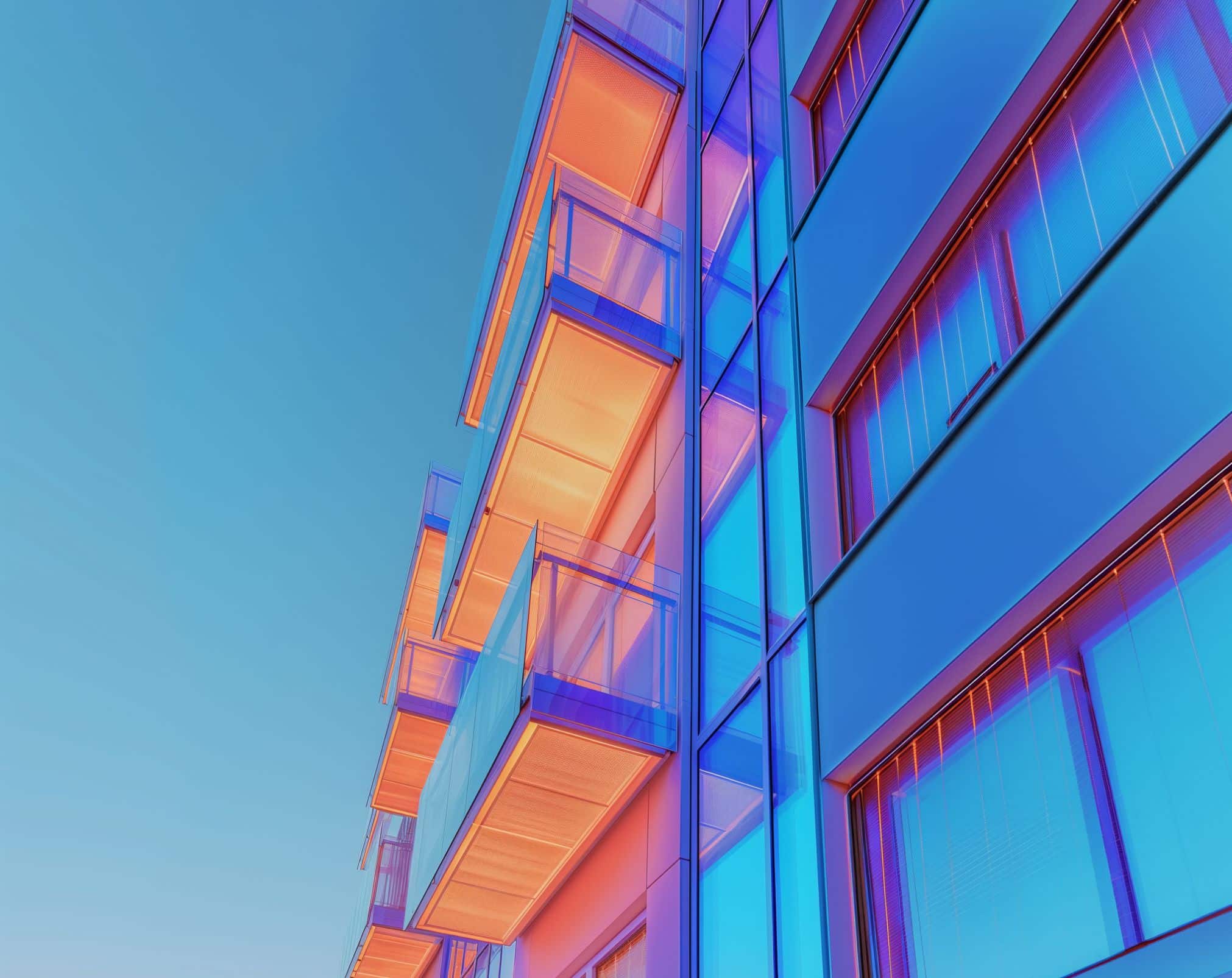 Multi-storey residential building with cantilevered balconies showing a common location for cold bridging where structural connections penetrate the building envelope